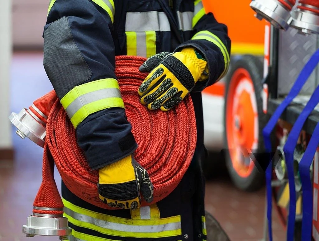Fire man rolling up fire hose